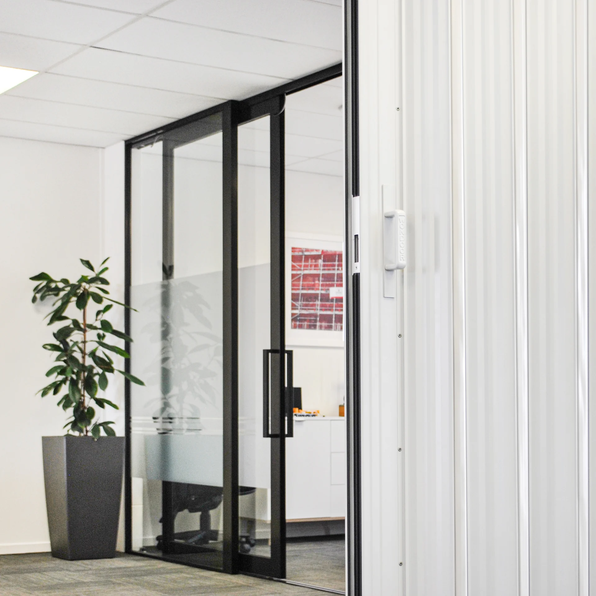 DuraSound acoustic accordion partition dividing open plan office workspaces