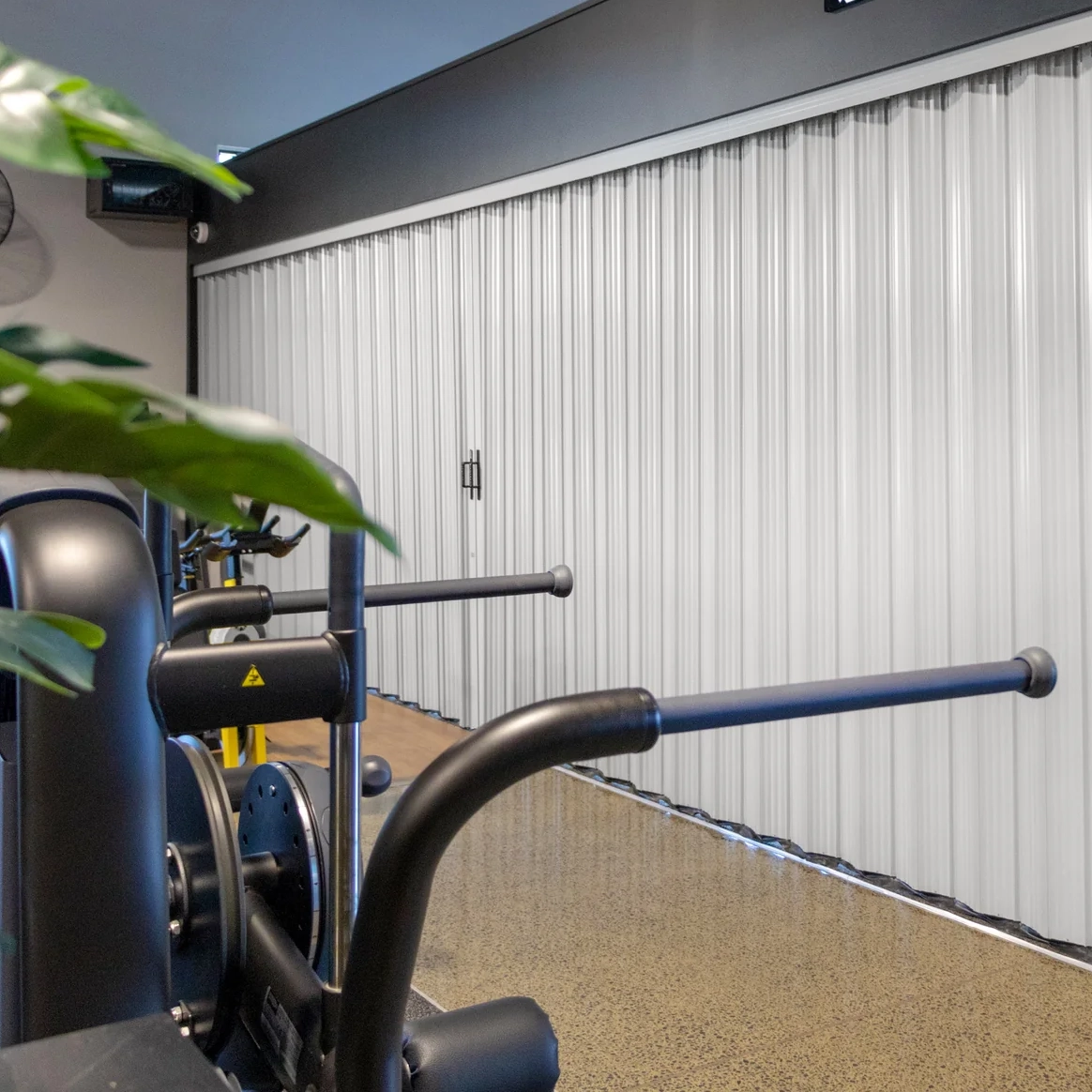 DuraFlex accordion partition dividing a gym space to create flexible workout areas