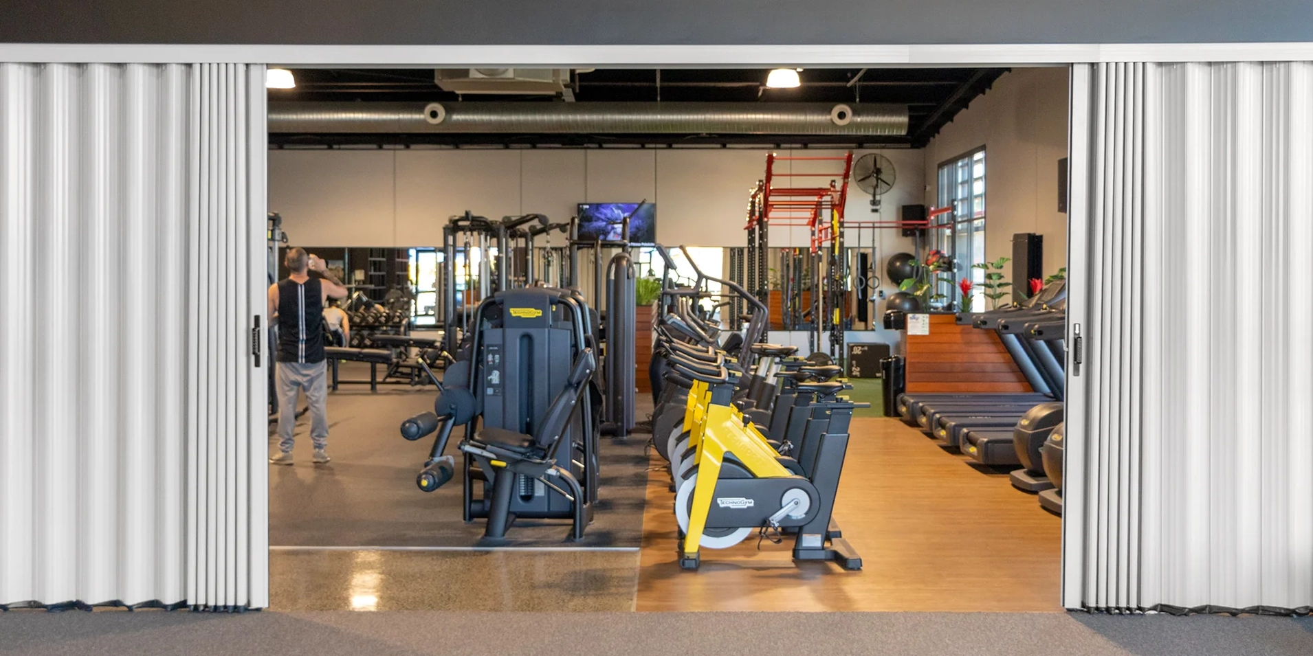 DuraFlex accordion partition opening up a gym space to create flexible workout areas