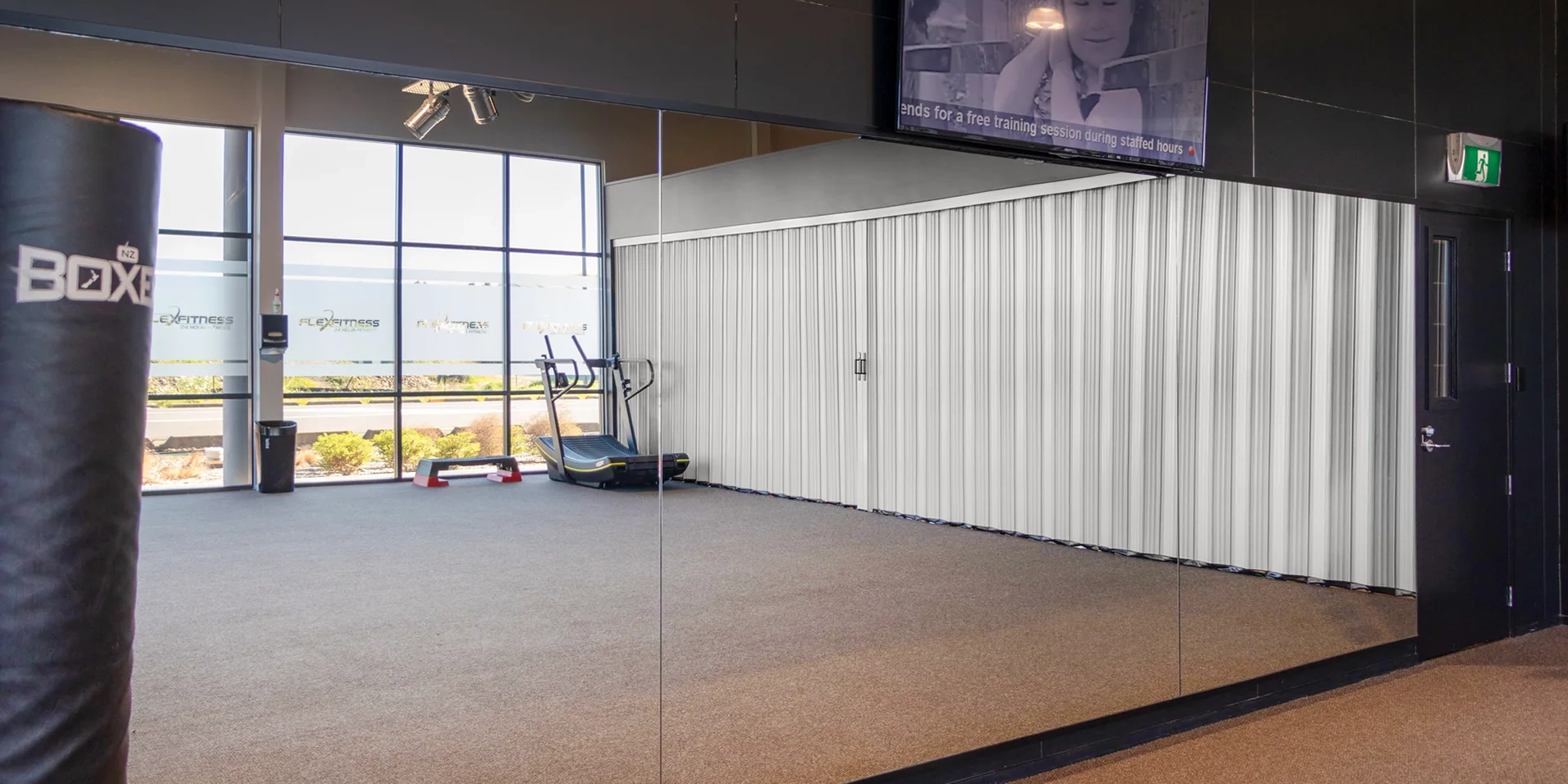 DuraFlex accordion partition dividing a gym space to create flexible workout areas