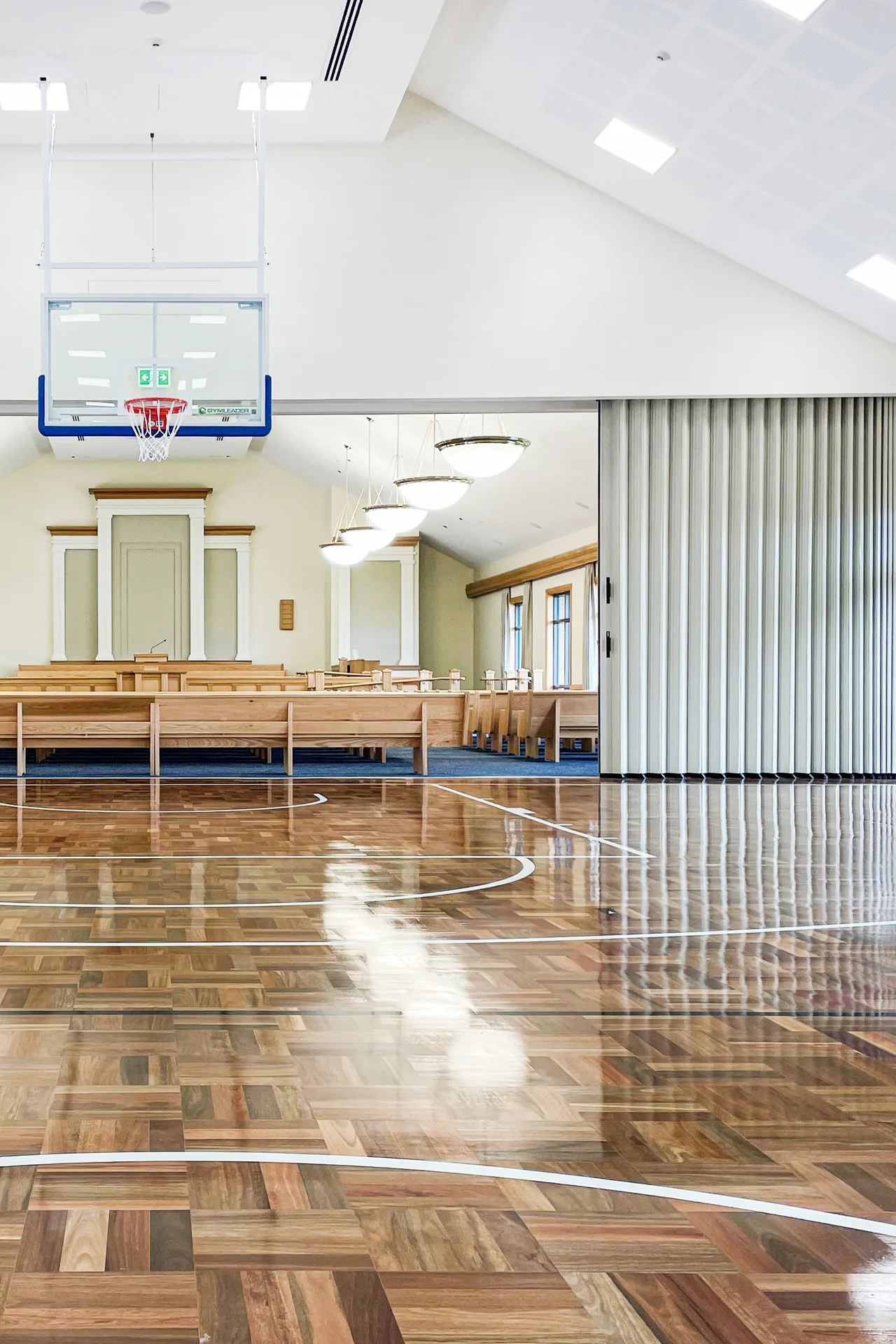 DuraSound acoustic accordion partition stacked to both sides spanning a sports hall to divide large multi-use spaces