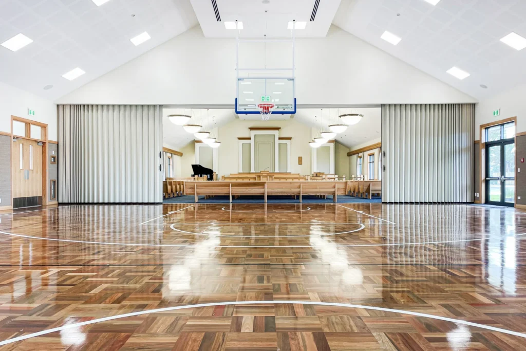 DuraSound acoustic accordion partition stacked to both sides spanning a sports hall to divide large multi-use spaces
