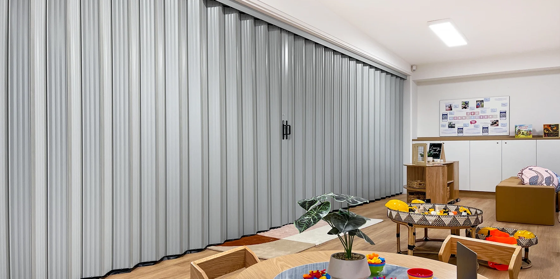 DuraFlex accordion partition dividing spaces in a childcare centre to create flexible play areas