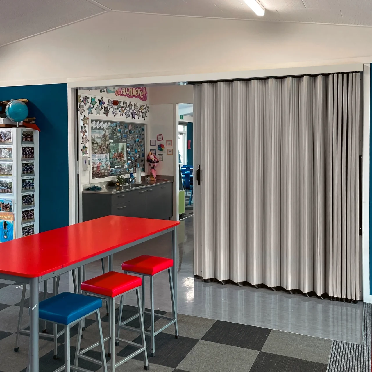 DuraSound acoustic accordion partition dividing classroom spaces in a school